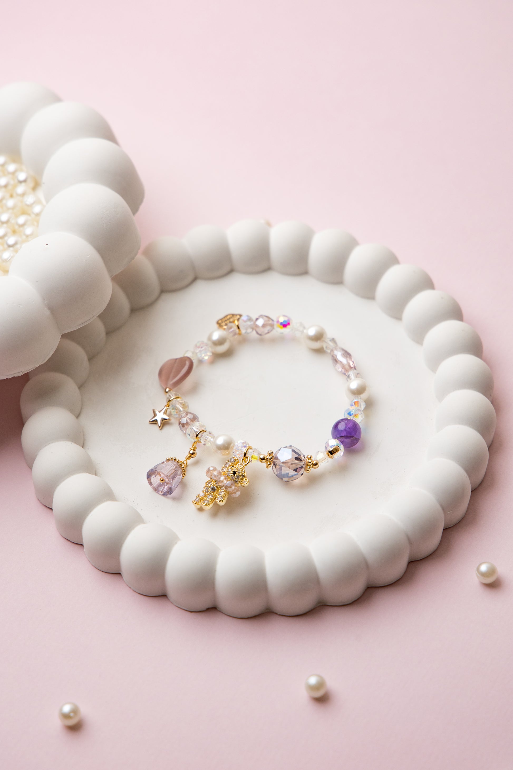 A charming mix of pastel beads with a gleaming gold-plated teddy bear, star, and heart charm—sweet enough for everyday wear or gifting.