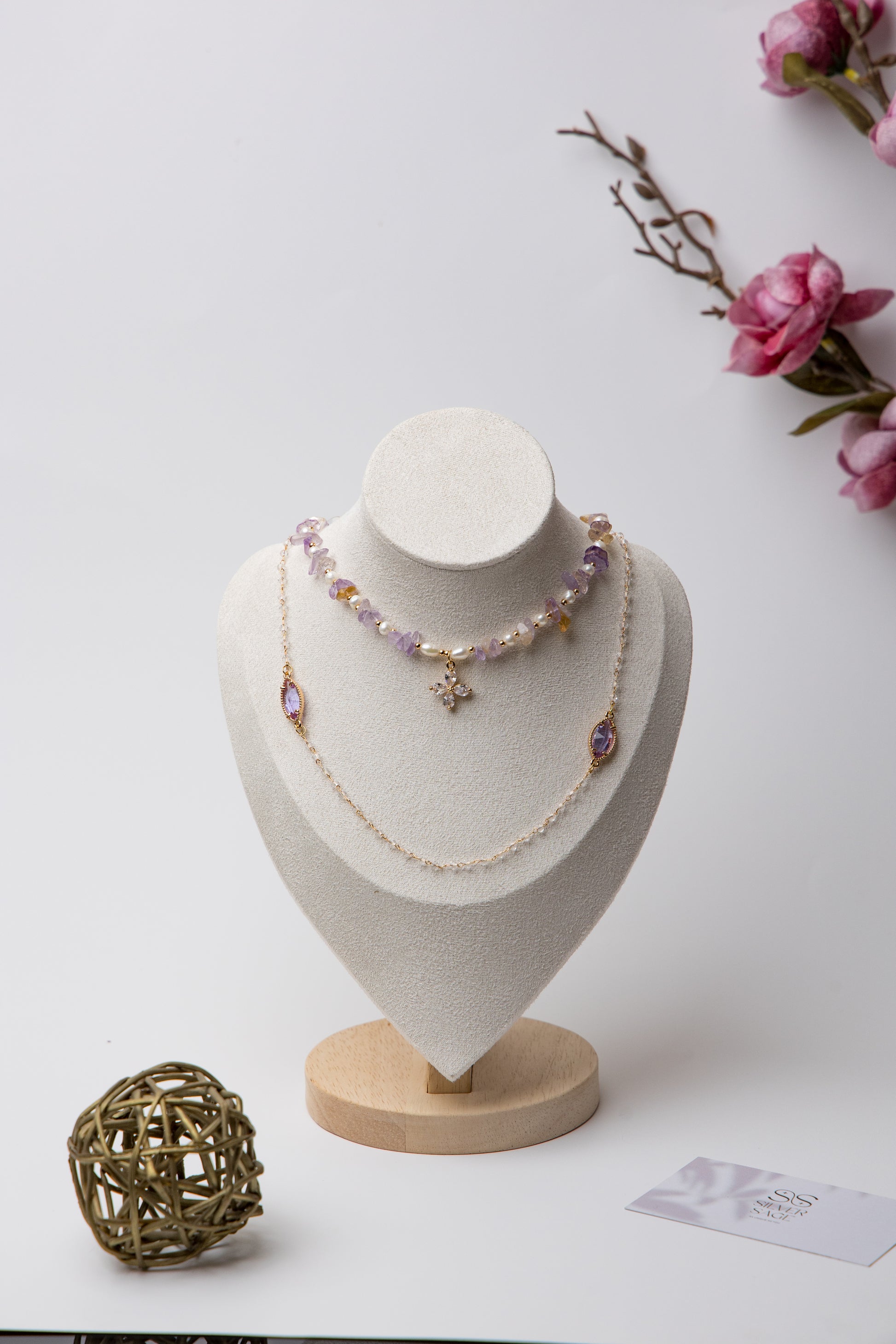 Three-tier necklace set with lavender amethyst stones, pearls, and a central floral crystal. A perfect mix of boho and elegance.
