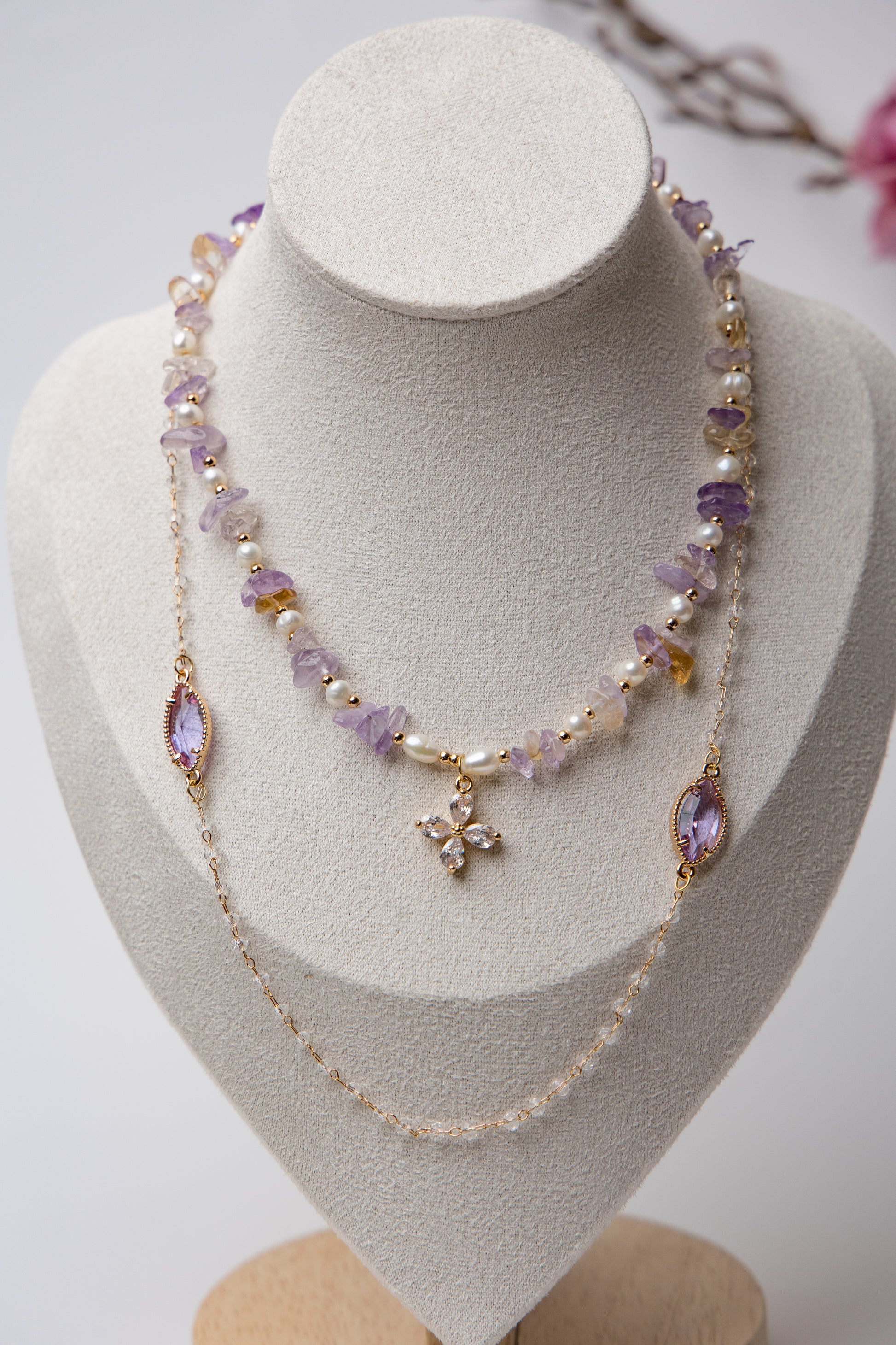 Three-tier necklace set with lavender amethyst stones, pearls, and a central floral crystal. A perfect mix of boho and elegance.