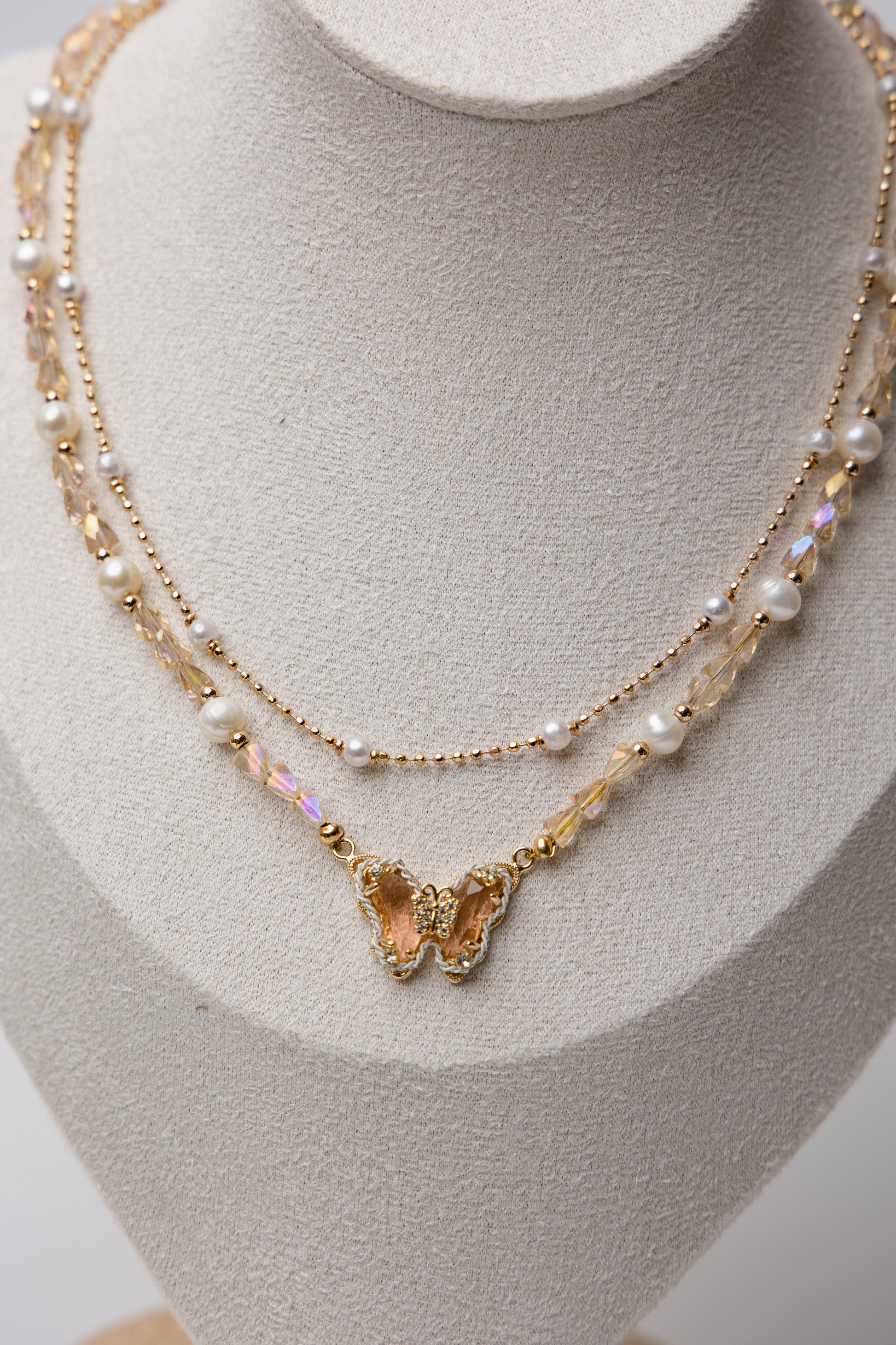 A dreamy blend of pearls, crystals, and butterfly charms for a whimsical touch.