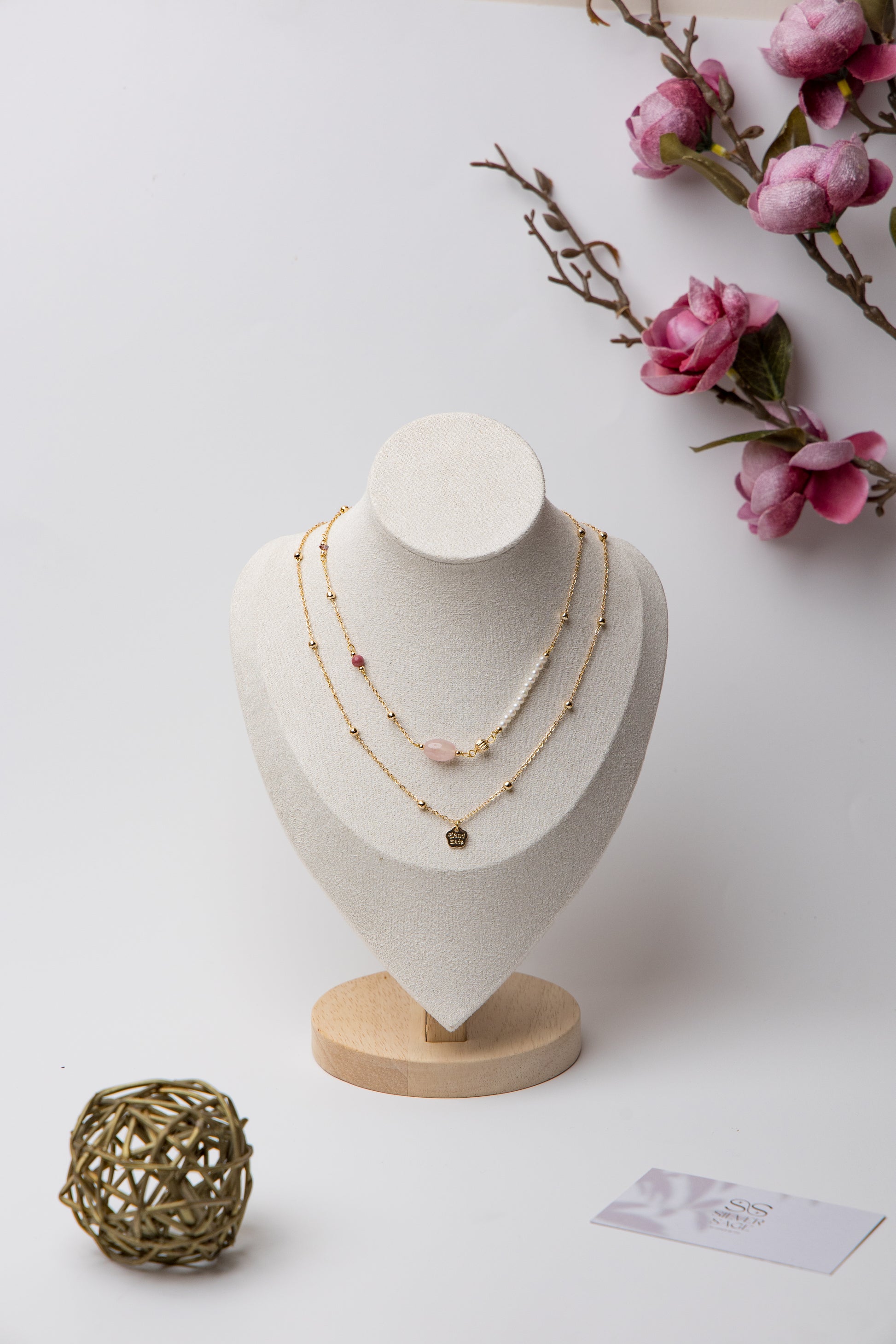 An elegant layered piece featuring a moonstone centerpiece with mixed textures and beadwork, blending classic and modern styles.