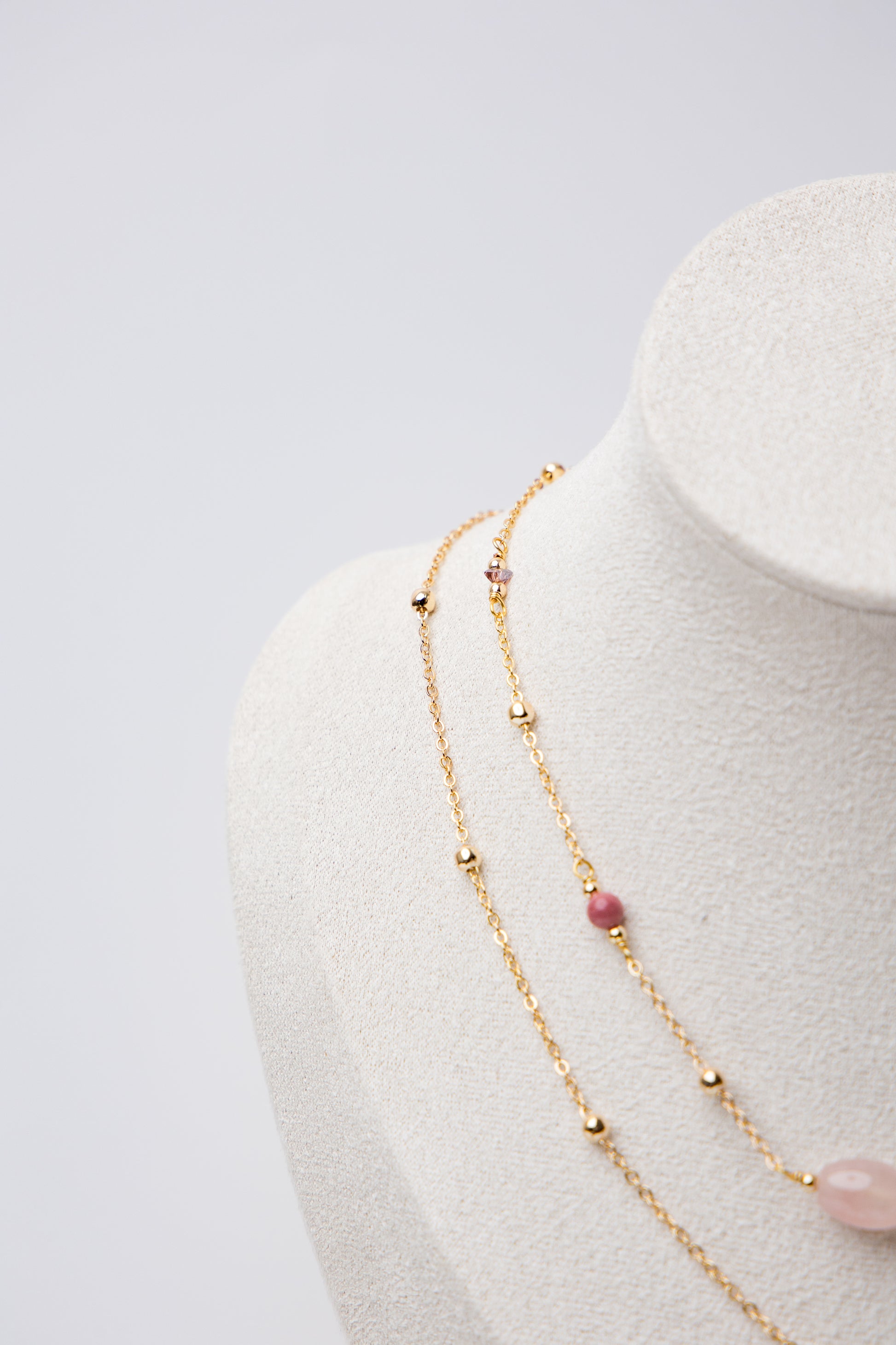 An elegant layered piece featuring a moonstone centerpiece with mixed textures and beadwork, blending classic and modern styles.