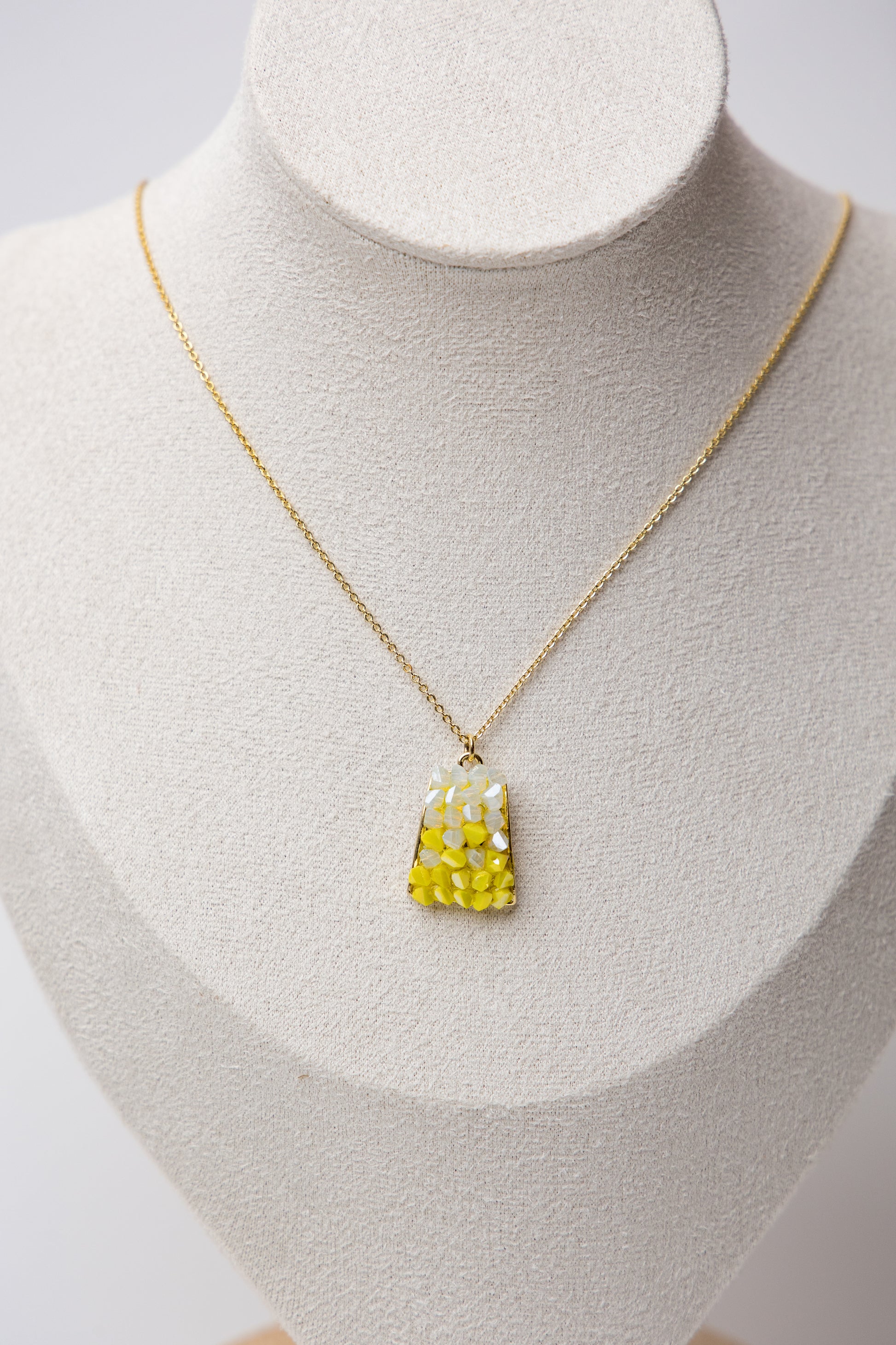 Brighten up your jewelry game with the Mosaic Gemstone Necklace in Sunshine Yellow. Featuring a handcrafted mosaic-style pendant with warm white and yellow gemstone pieces.
