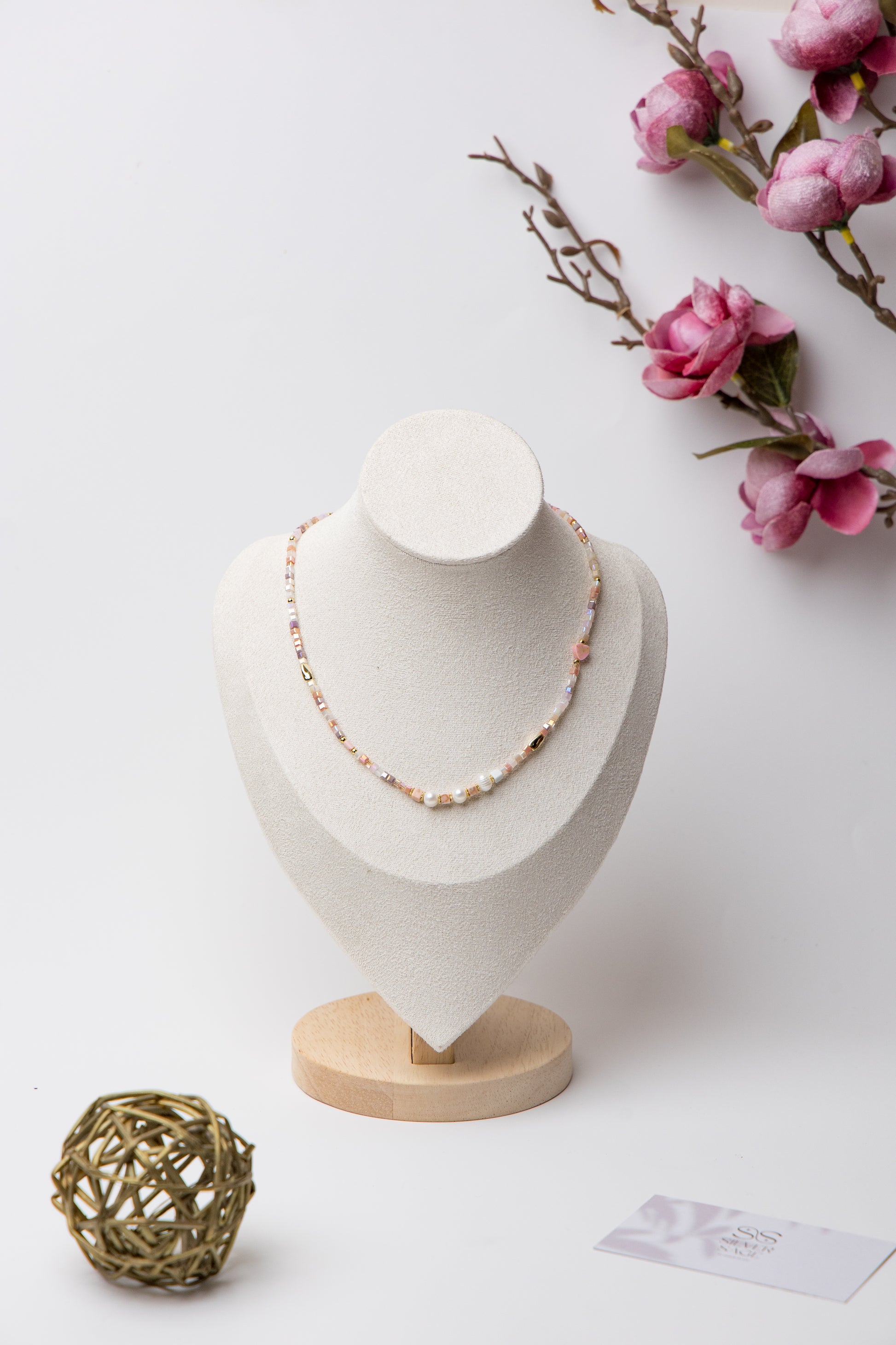 Pearl Glow Beaded Necklace in Blush Pink with pastel pink cube beads, luminous freshwater pearls, and gold accents, offering a soft and elegant statement piece.