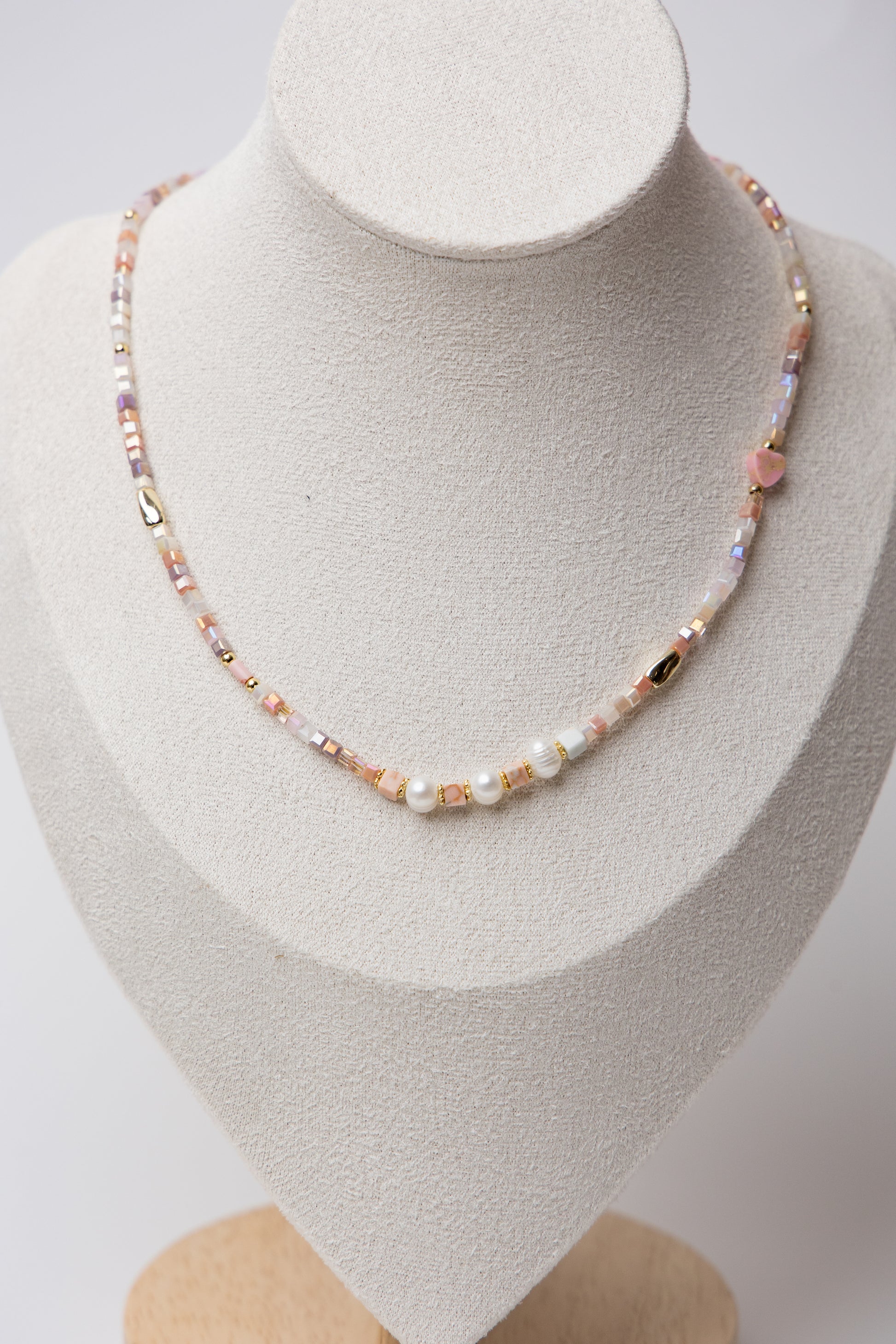 Pearl Glow Beaded Necklace in Blush Pink with pastel pink cube beads, luminous freshwater pearls, and gold accents, offering a soft and elegant statement piece.