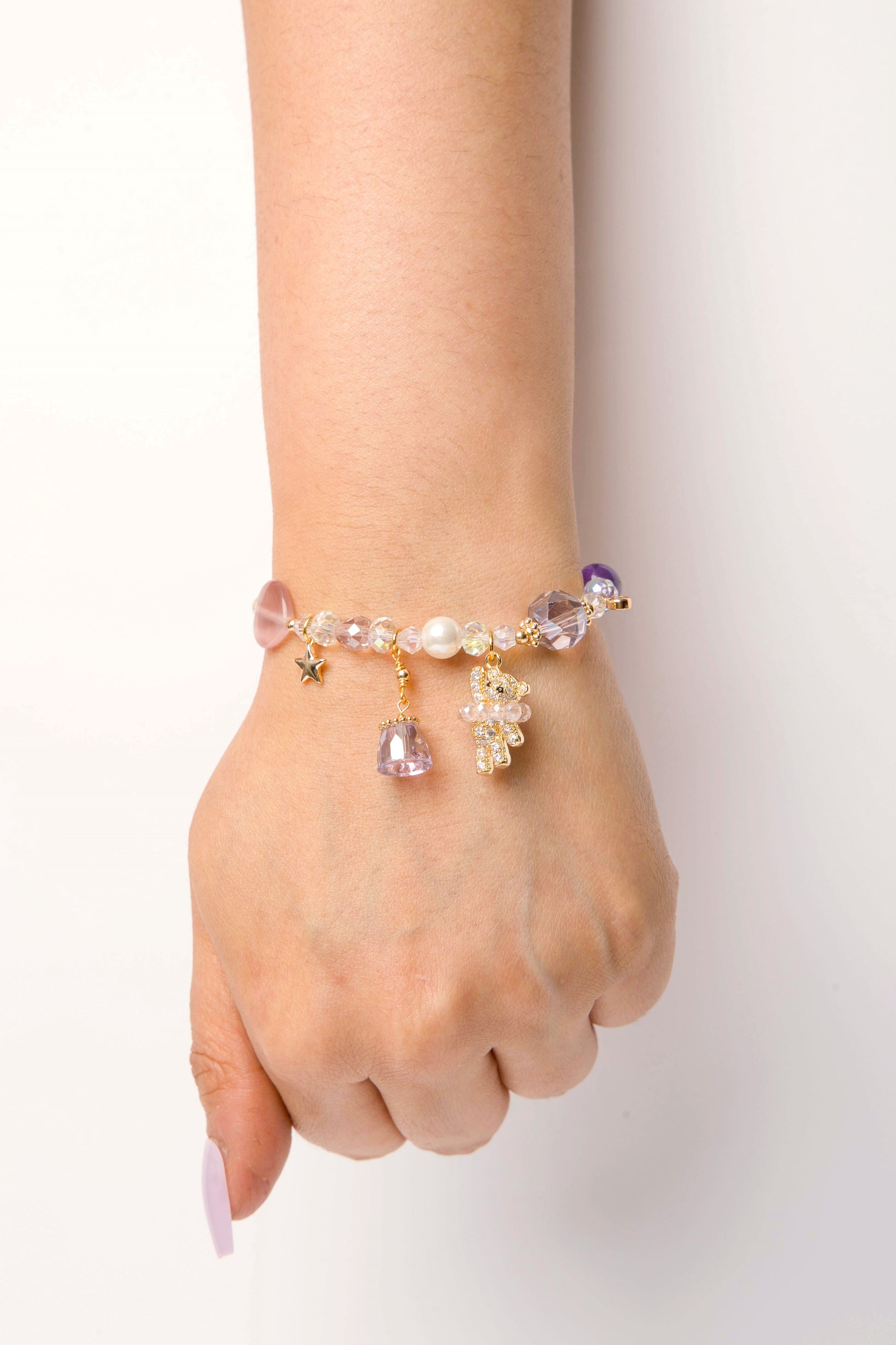 A charming mix of pastel beads with a gleaming gold-plated teddy bear, star, and heart charm—sweet enough for everyday wear or gifting.