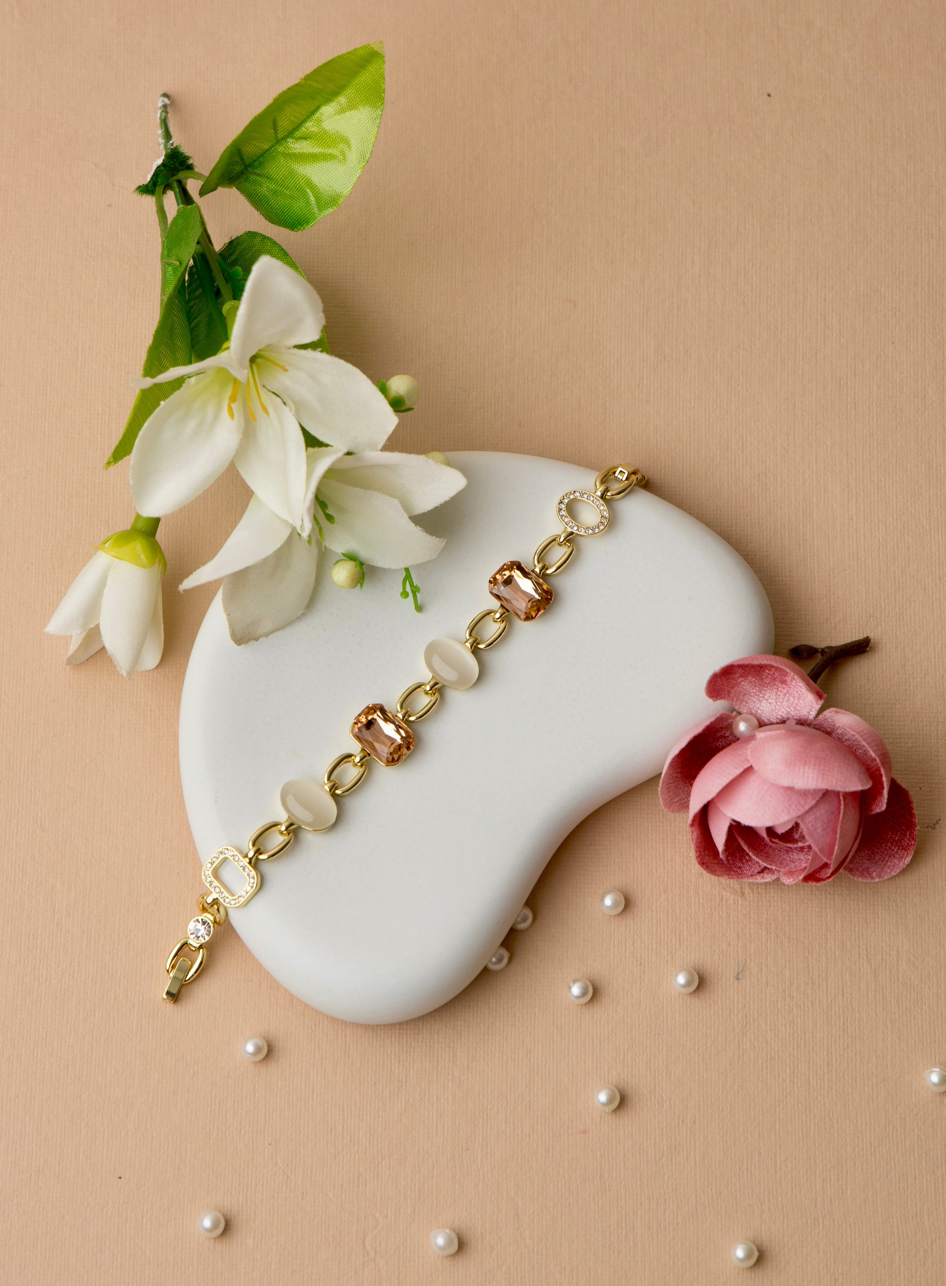 "Gold-plated bracelet featuring mocha crystals and ivory enamel, ideal for workwear or elegant neutral styling."
