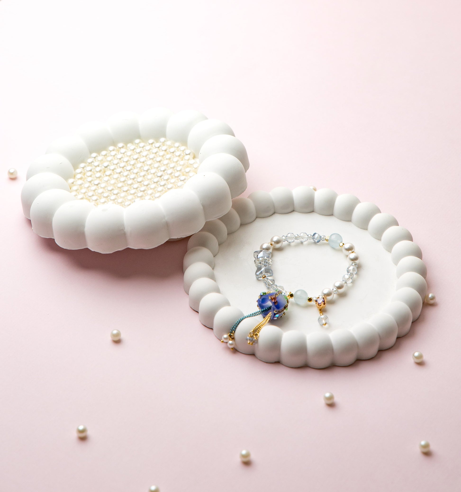 Featuring an elegant blue rose charm with pearl & aquamarine beads and flowing tassel accent.