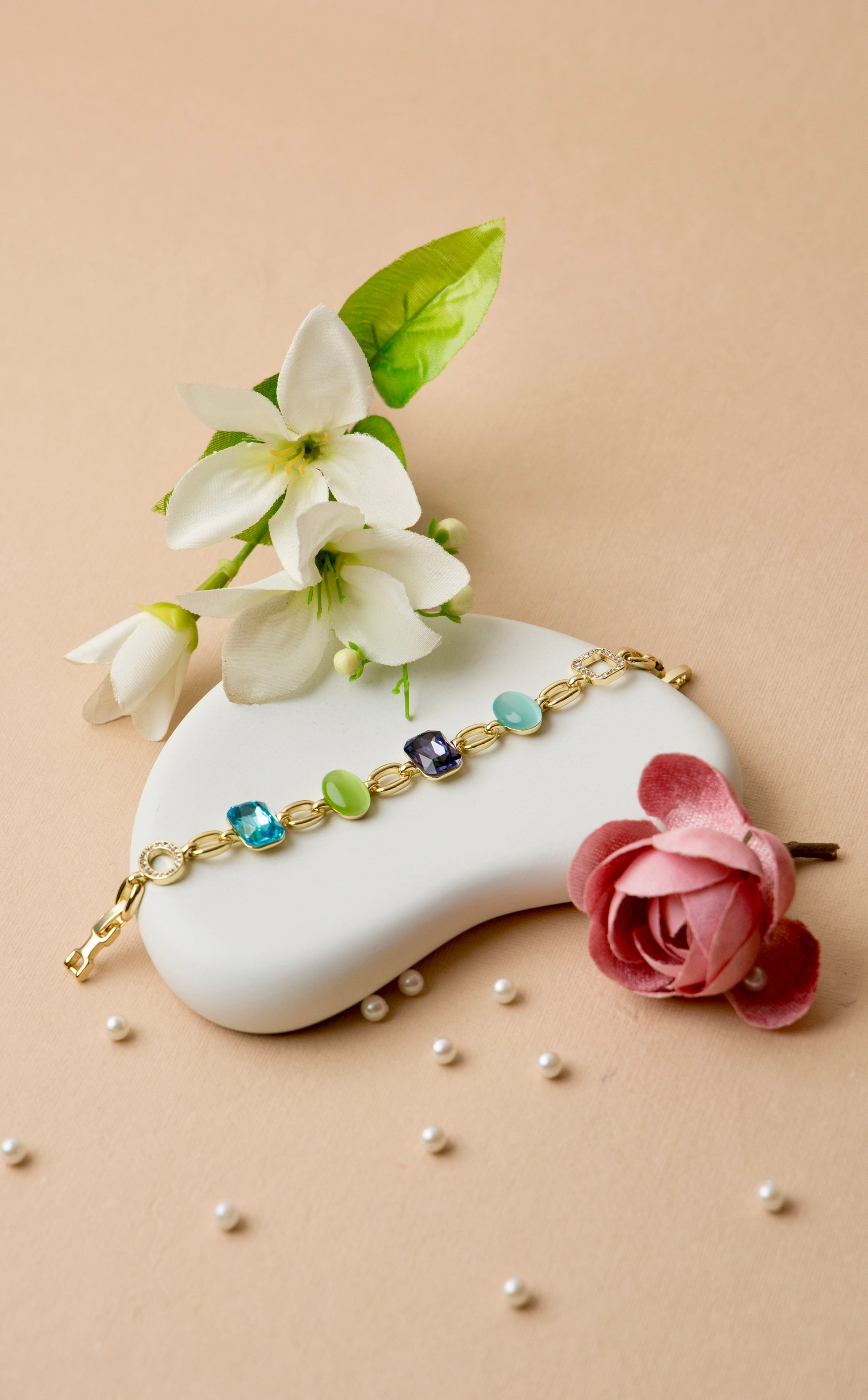 This bold crystal bracelet brings together amethyst and jade-toned resin with multicolor pops