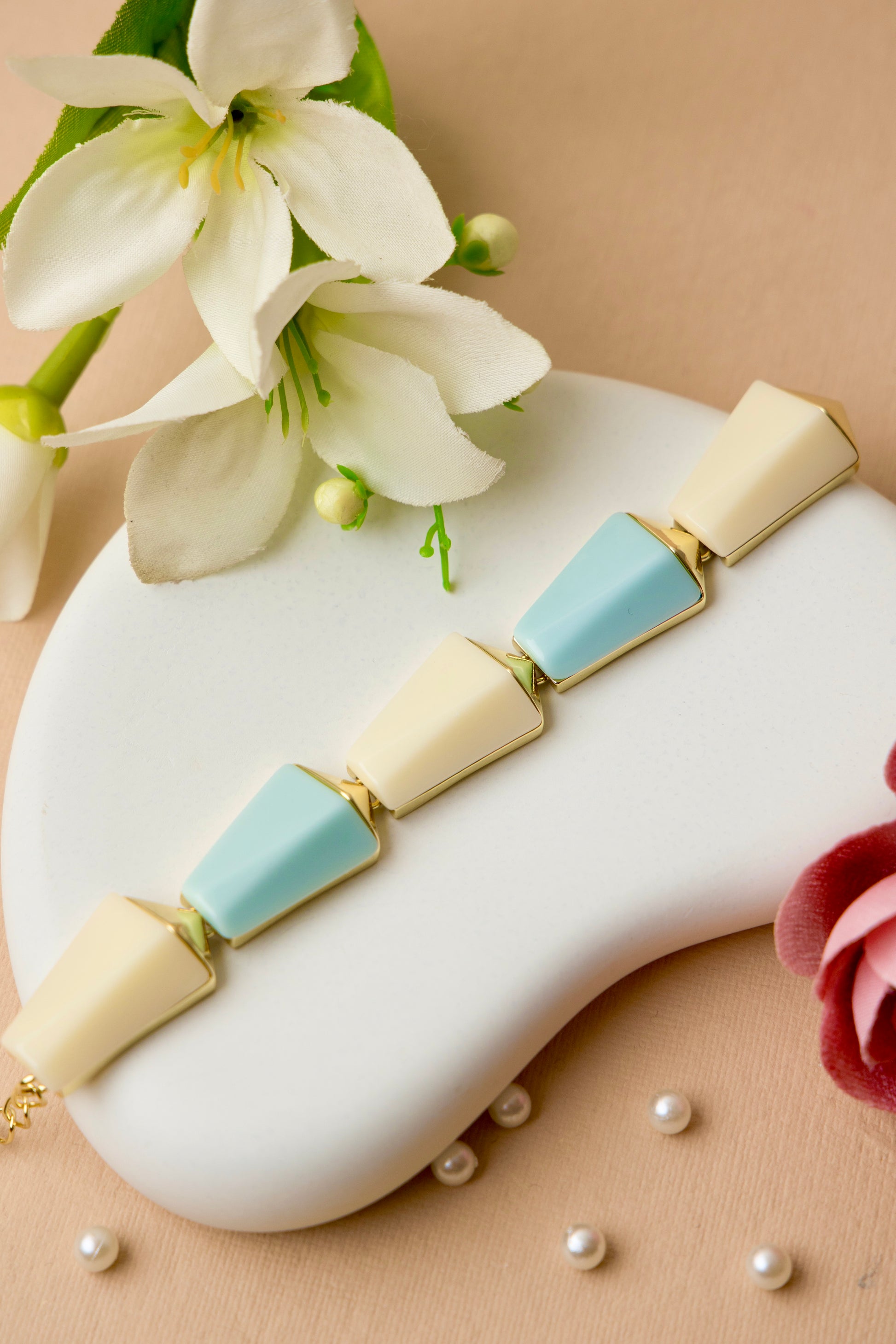 "Sky Prism Bracelet with cream and pastel blue color blocks in a sleek geometric design, blending modern angles with a soft, versatile palette."