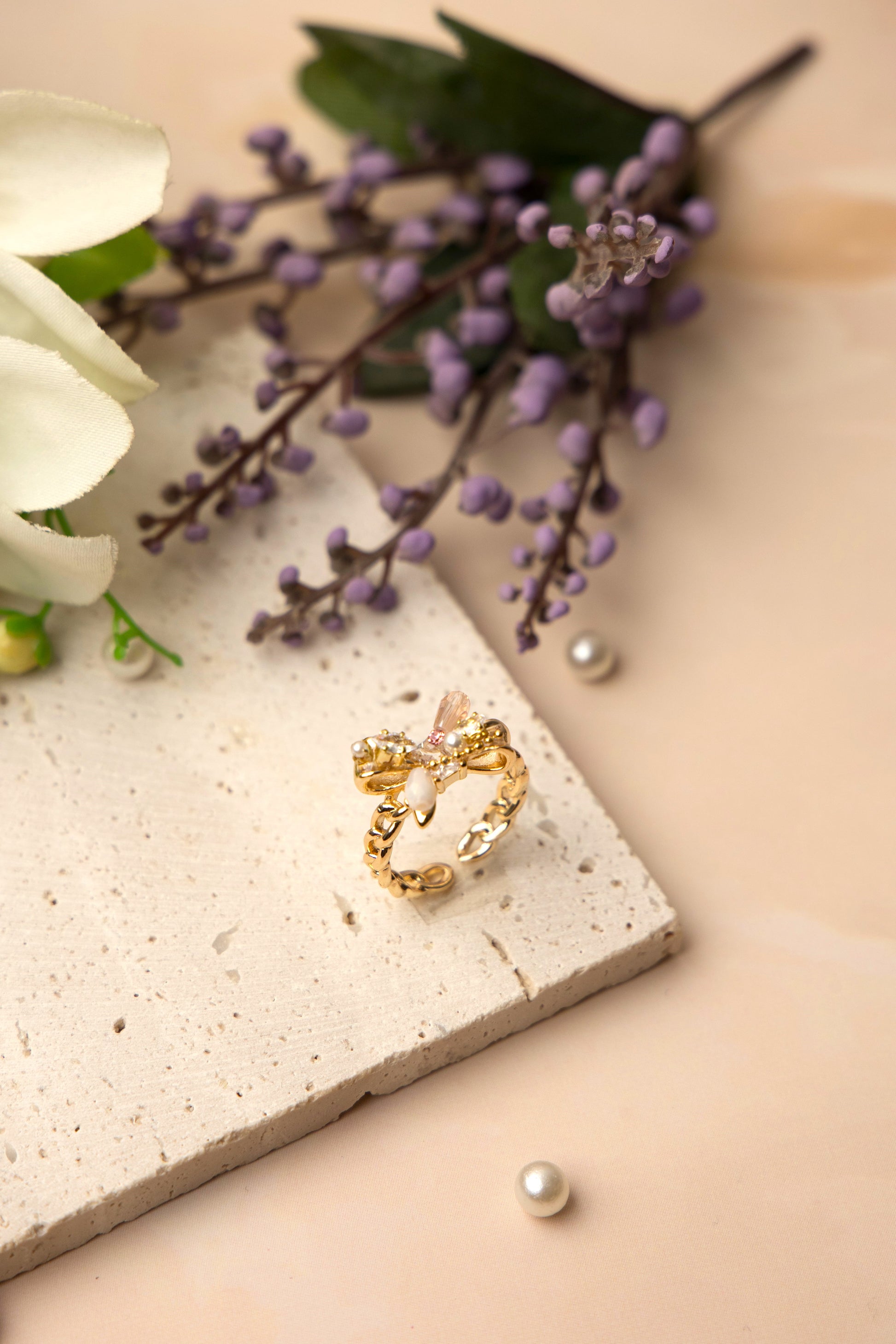 The Aurora Bow Ring is lavishly adorned with lustrous pearls and hand-set crystals in varying cuts and tones.