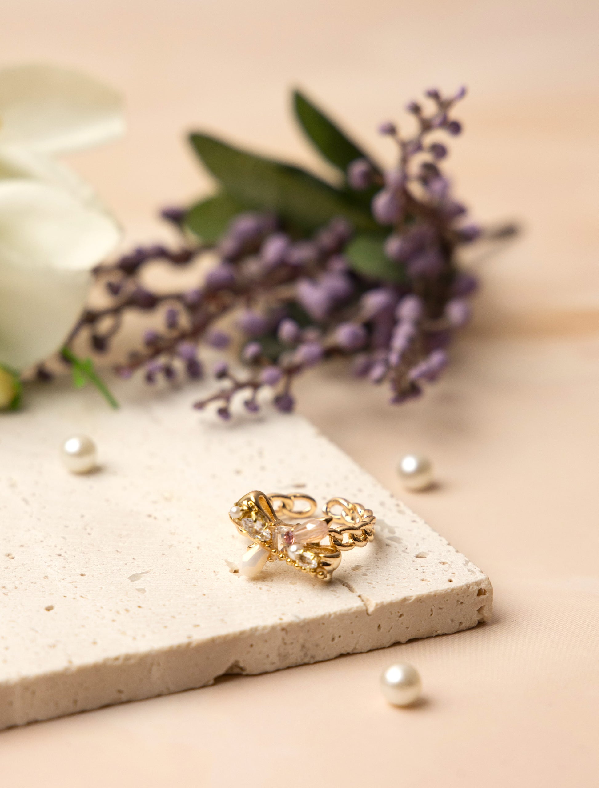 The Aurora Bow Ring is lavishly adorned with lustrous pearls and hand-set crystals in varying cuts and tones.