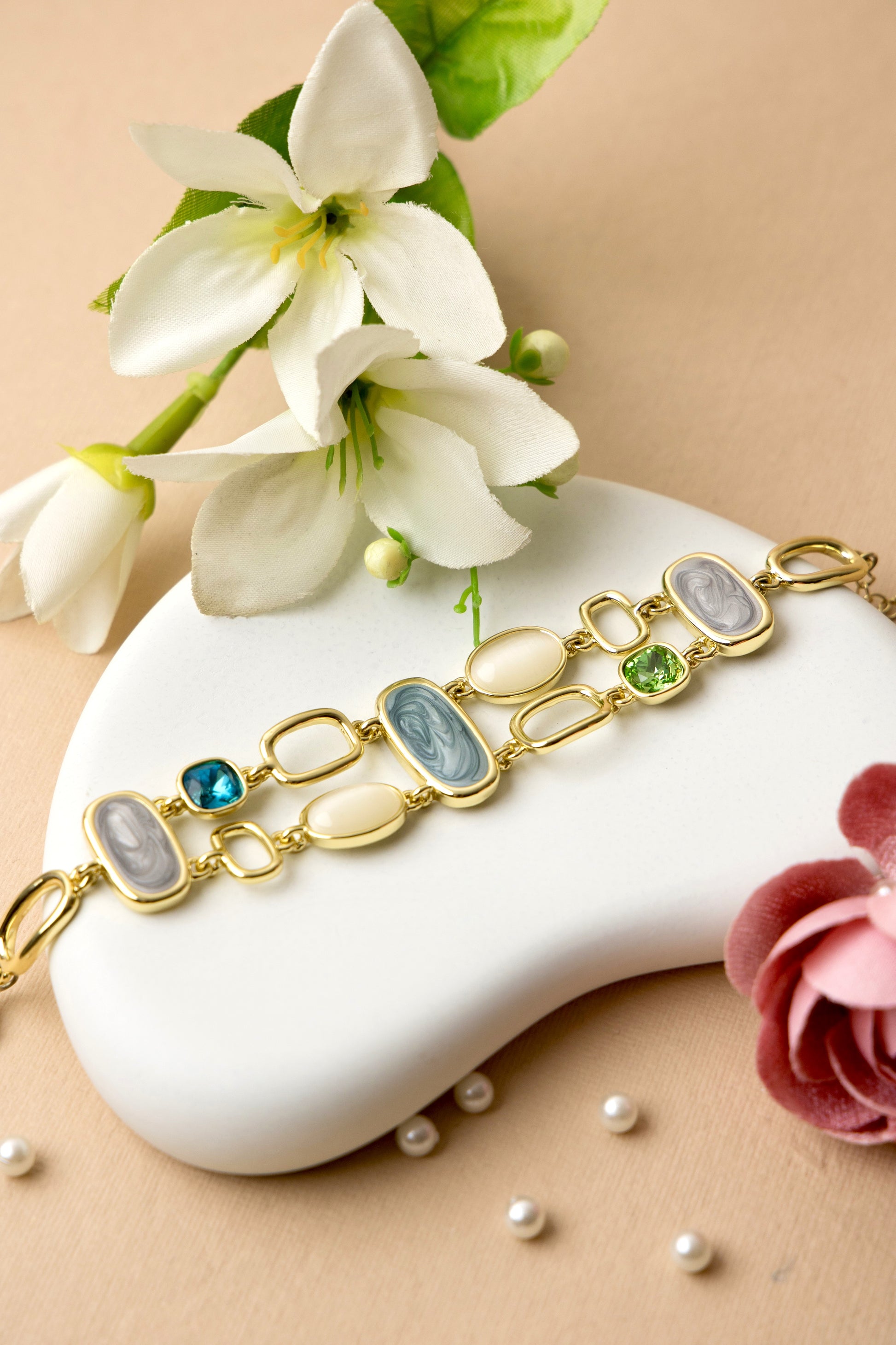 "Dual-strand bracelet with agate-inspired resin and crystal links, offering a luxe, layered look ideal for evening or festive wear."