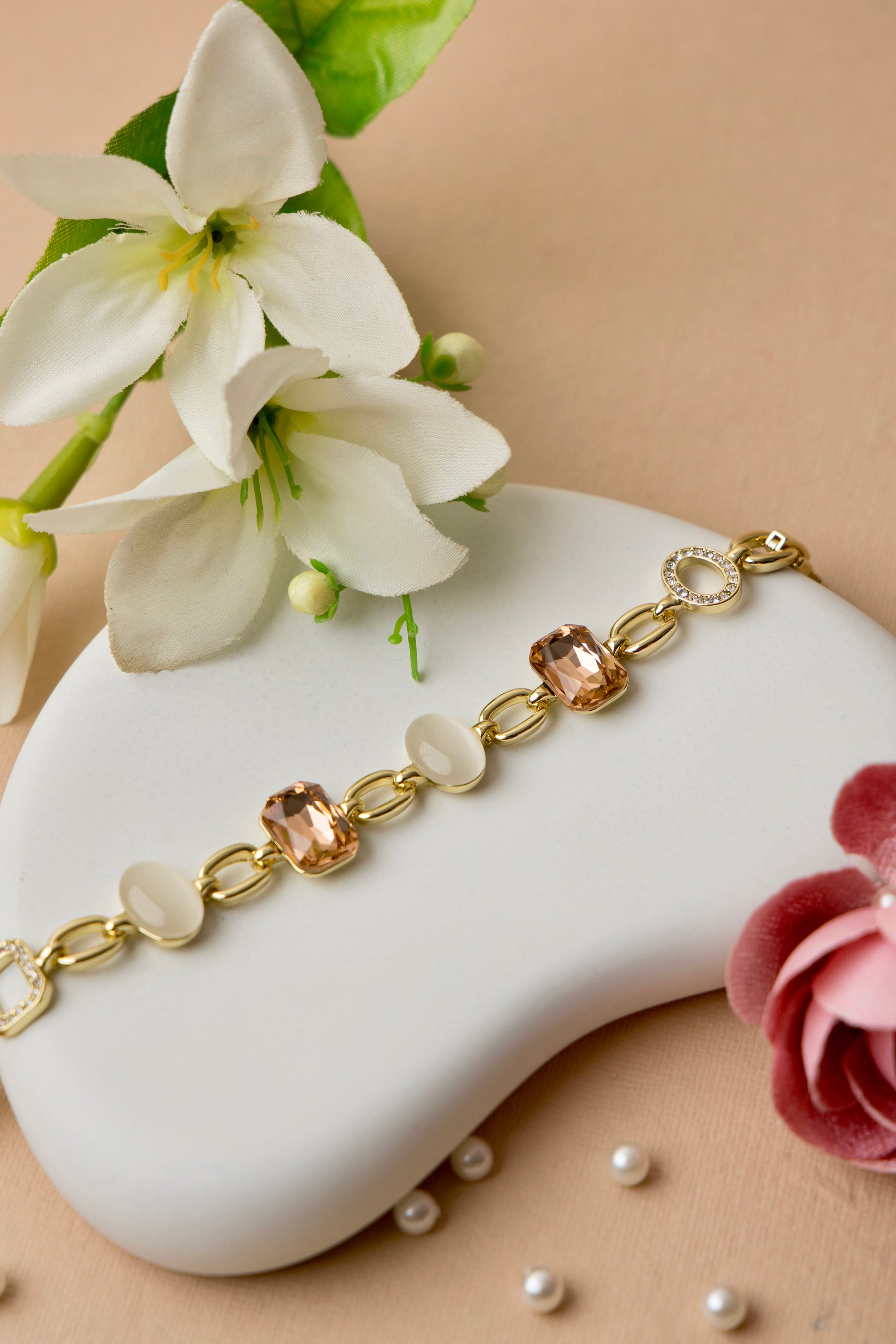"Gold-plated bracelet featuring mocha crystals and ivory enamel, ideal for workwear or elegant neutral styling."