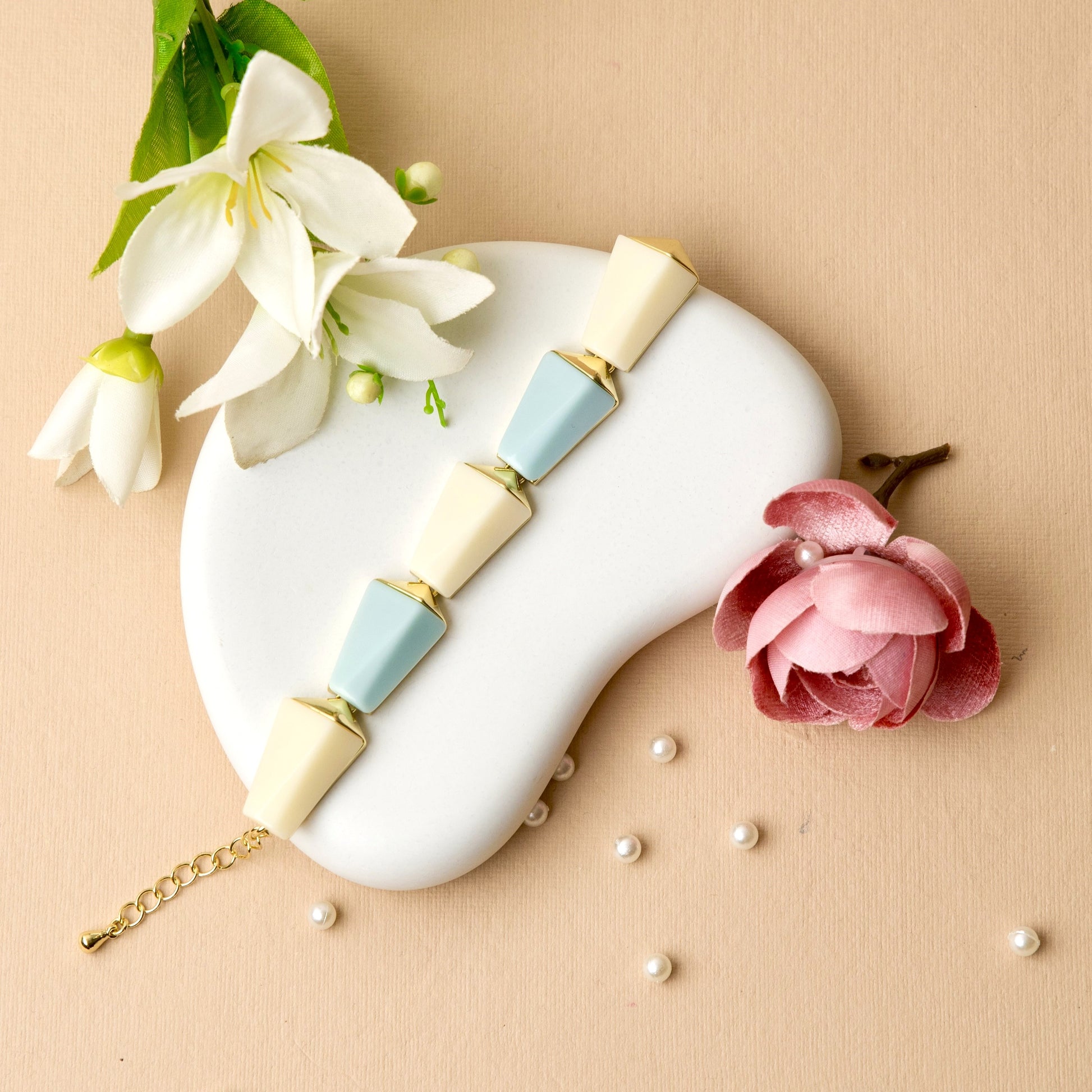 "Sky Prism Bracelet with cream and pastel blue color blocks in a sleek geometric design, blending modern angles with a soft, versatile palette."