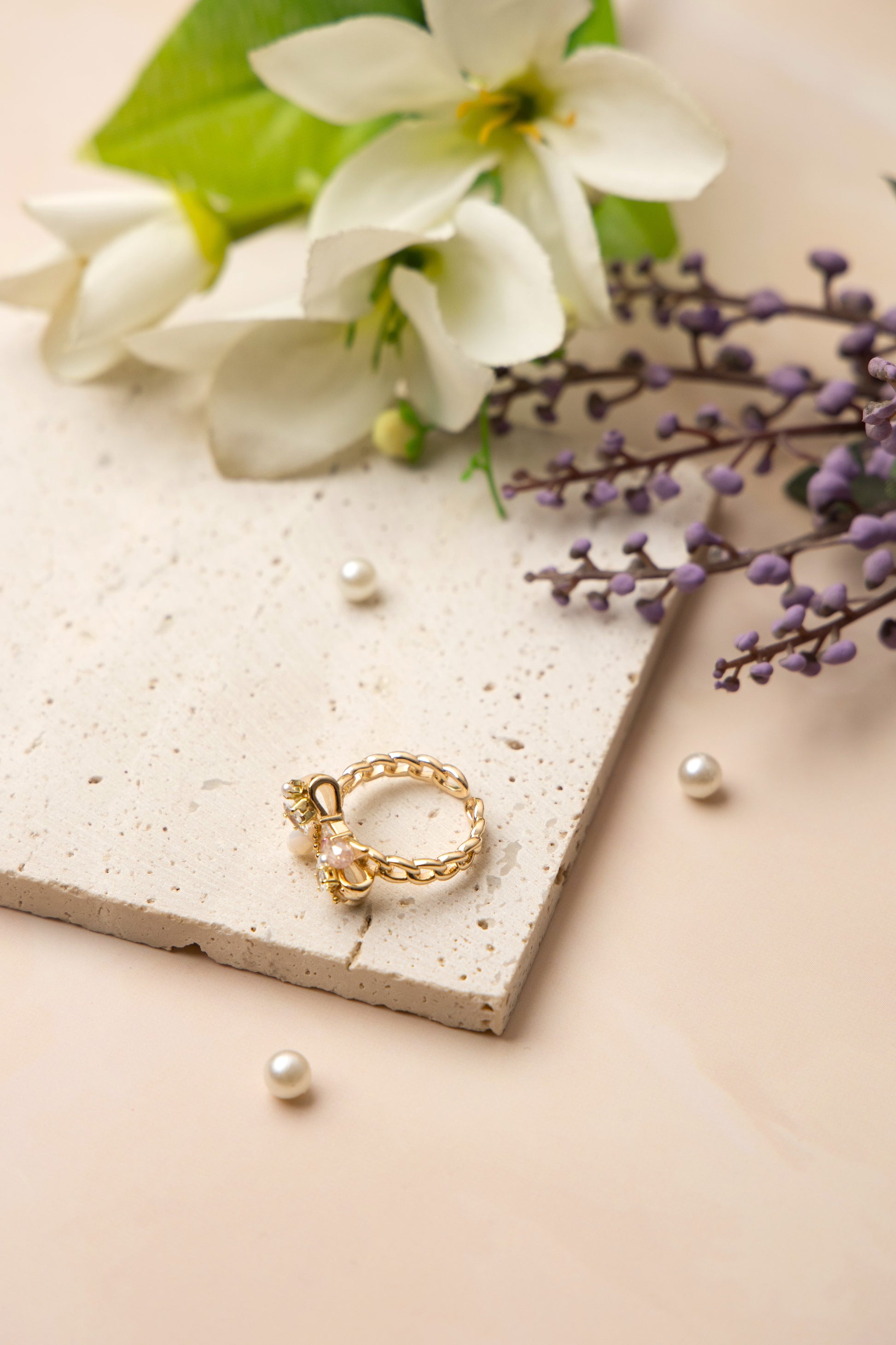 The Aurora Bow Ring is lavishly adorned with lustrous pearls and hand-set crystals in varying cuts and tones.