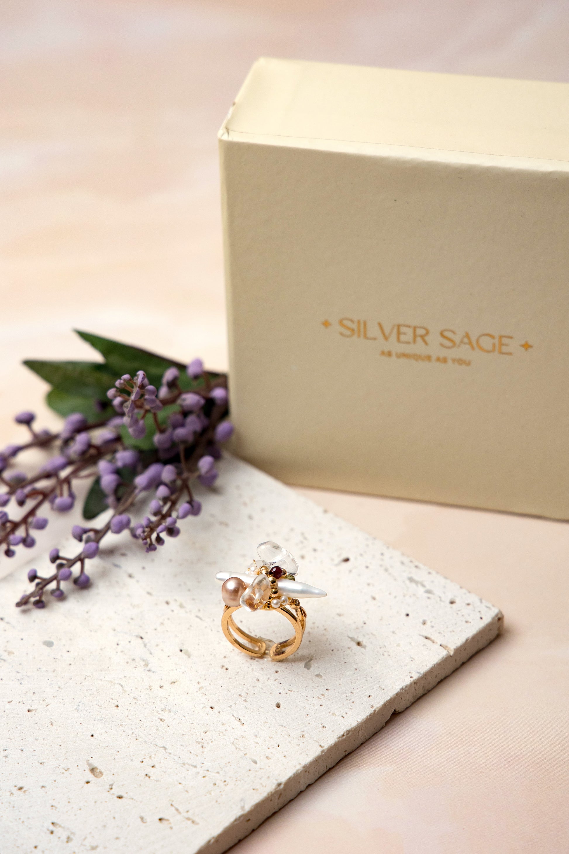 The Elysian Bloom Ring features a luminous fox pearl at its center, accented with a mix of soft pearls and delicate gemstones.