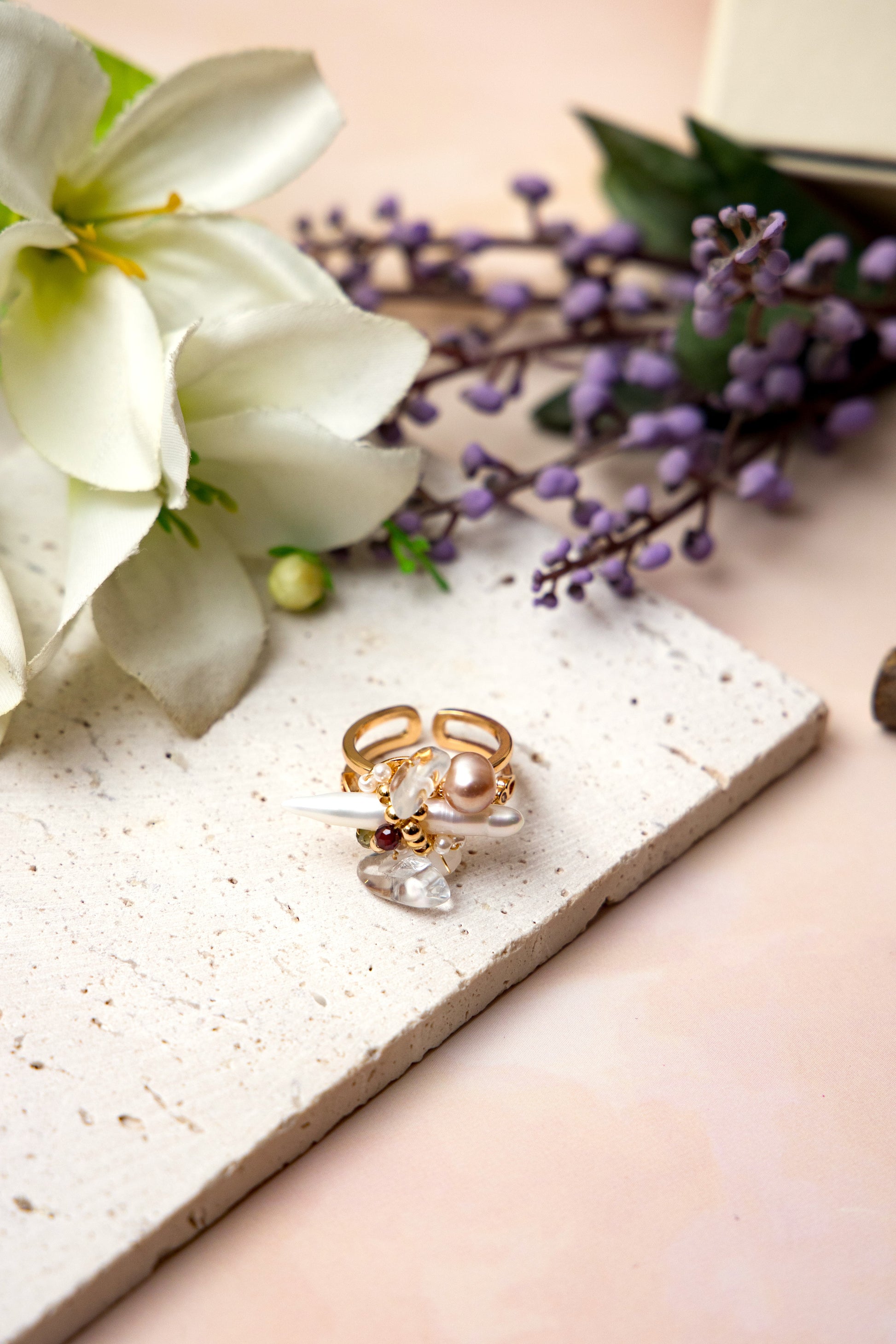 The Elysian Bloom Ring features a luminous fox pearl at its center, accented with a mix of soft pearls and delicate gemstones.