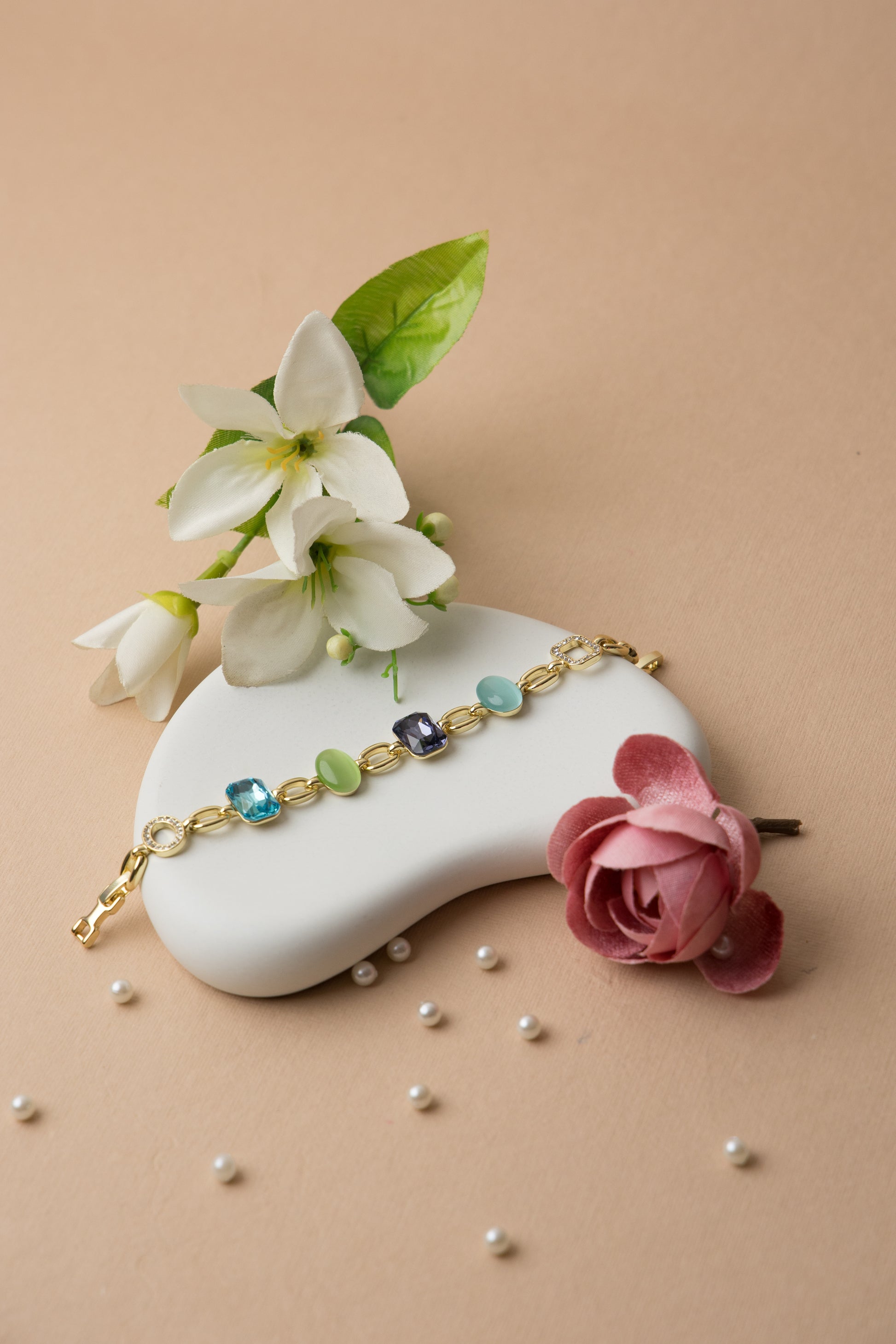 This bold crystal bracelet brings together amethyst and jade-toned resin with multicolor pops