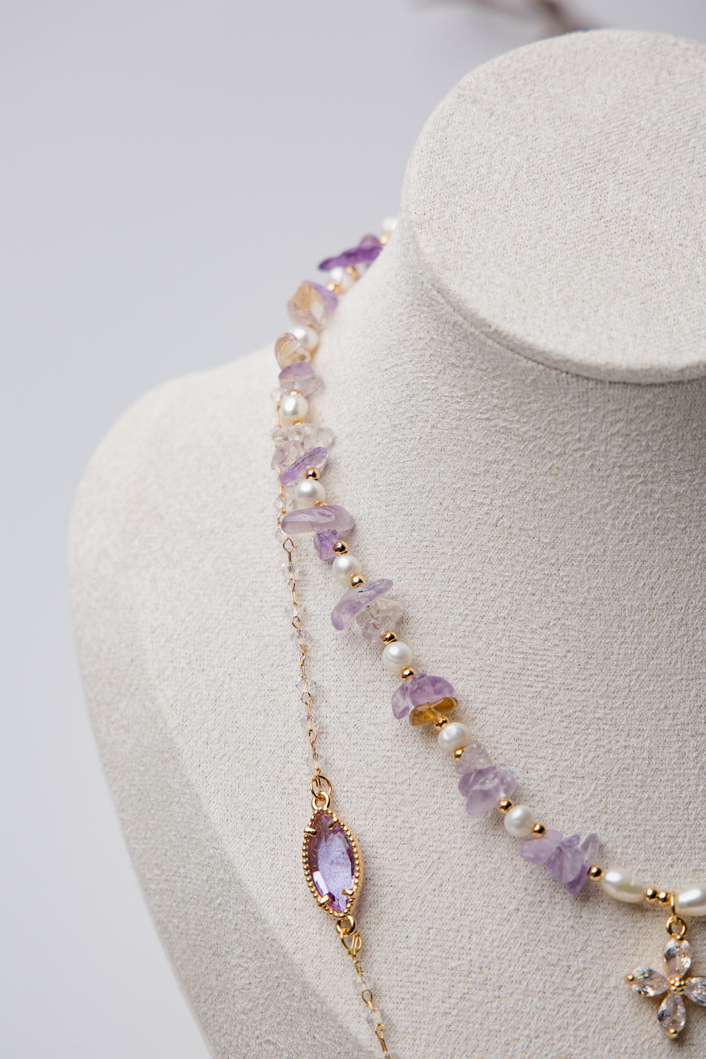 Three-tier necklace set with lavender amethyst stones, pearls, and a central floral crystal. A perfect mix of boho and elegance.