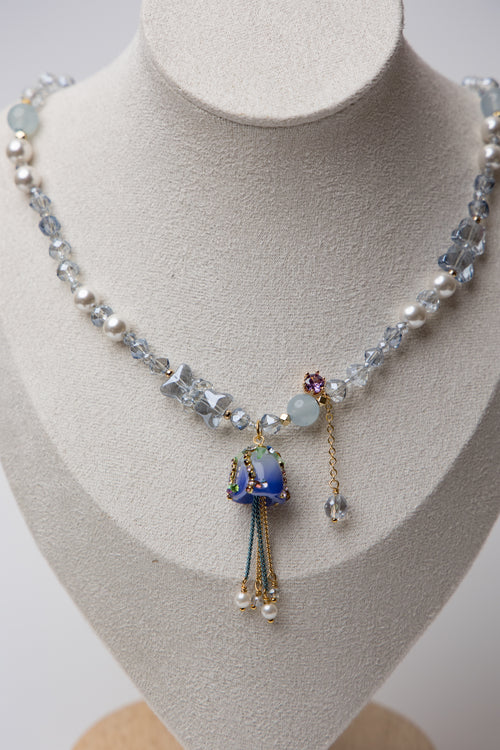 A dreamy floral-inspired necklace with pearls and a delicate rose charm. Adds a touch of whimsy and charm to your look.