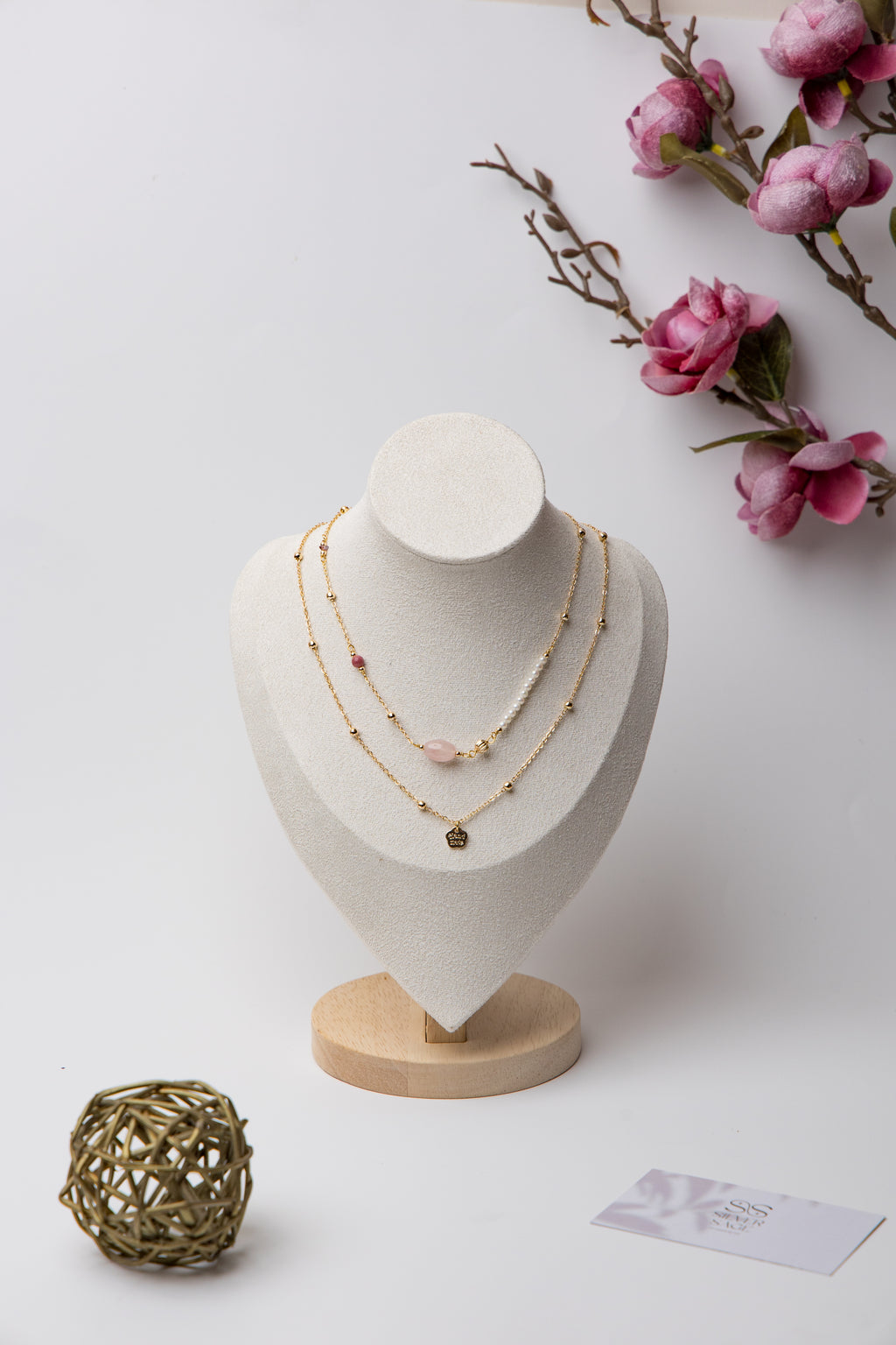 An elegant layered piece featuring a moonstone centerpiece with mixed textures and beadwork, blending classic and modern styles.