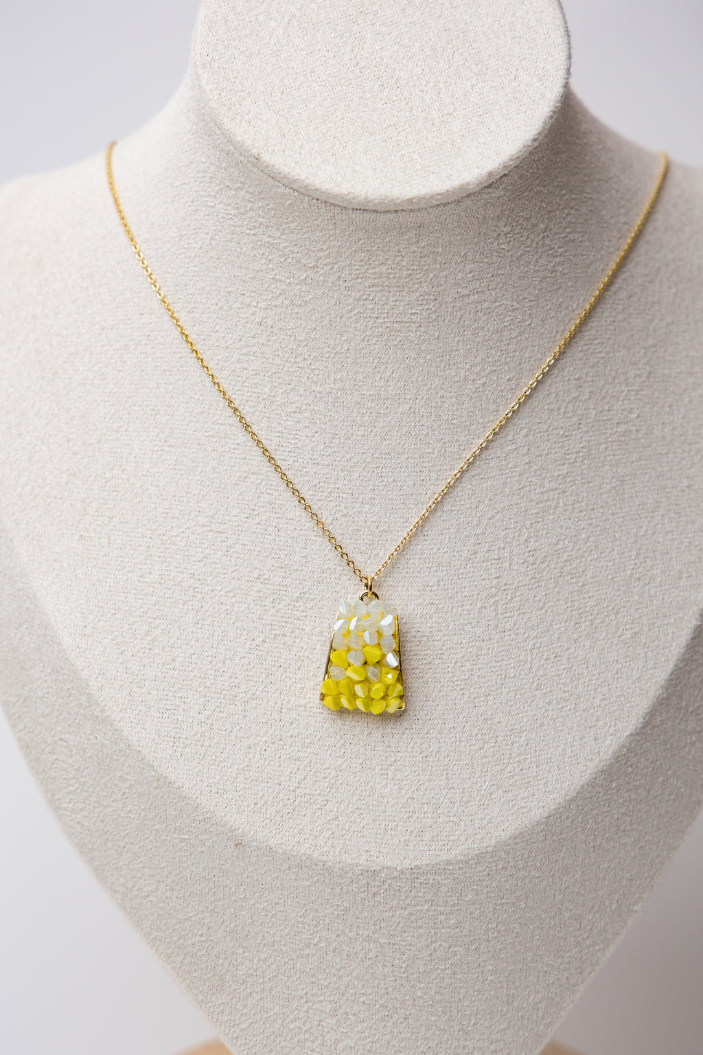 Brighten up your jewelry game with the Mosaic Gemstone Necklace in Sunshine Yellow. Featuring a handcrafted mosaic-style pendant with warm white and yellow gemstone pieces.