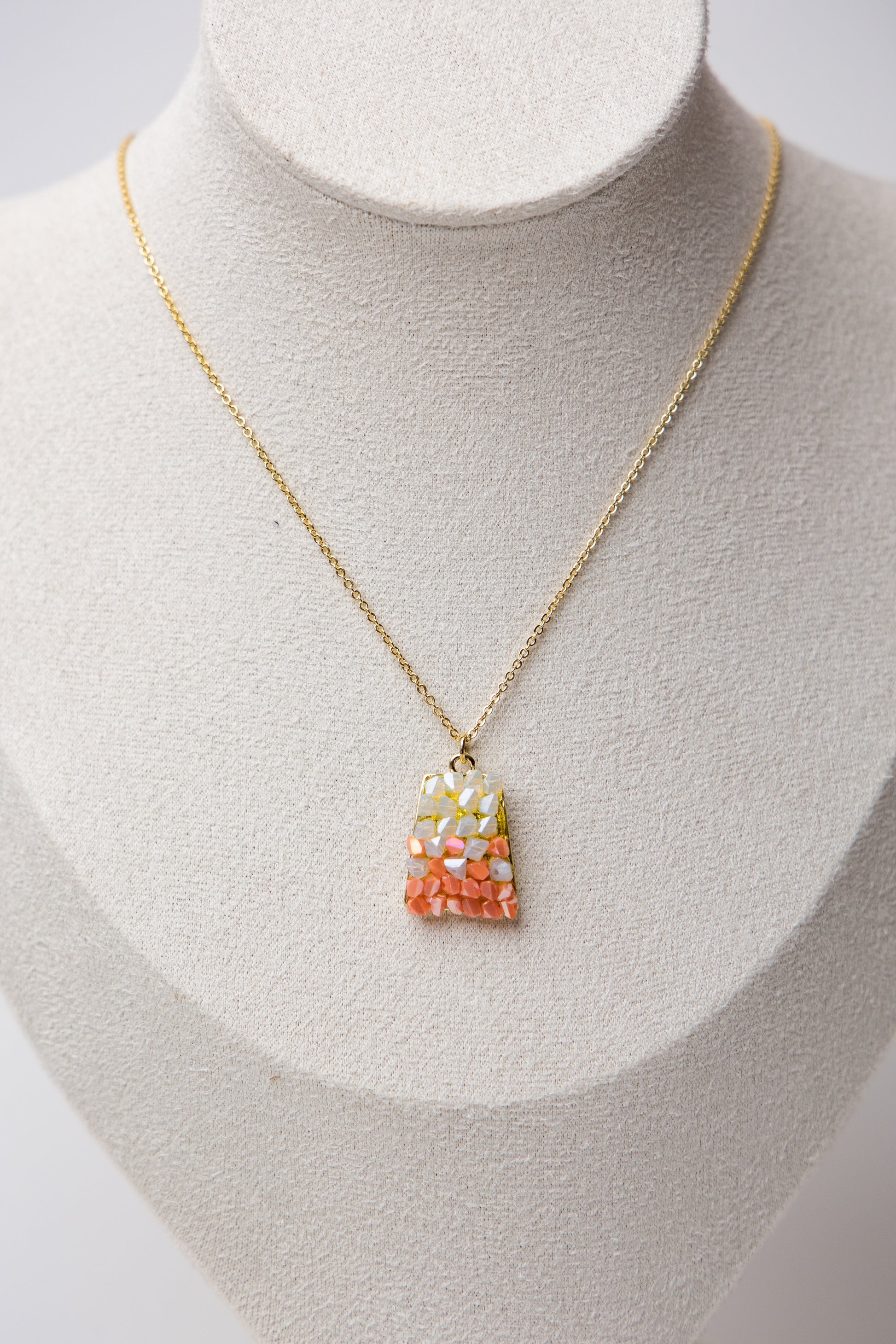 Crafted with a unique blend of colorful gemstone shards set in a modern teardrop base, this necklace exudes bold elegance.&nbsp;