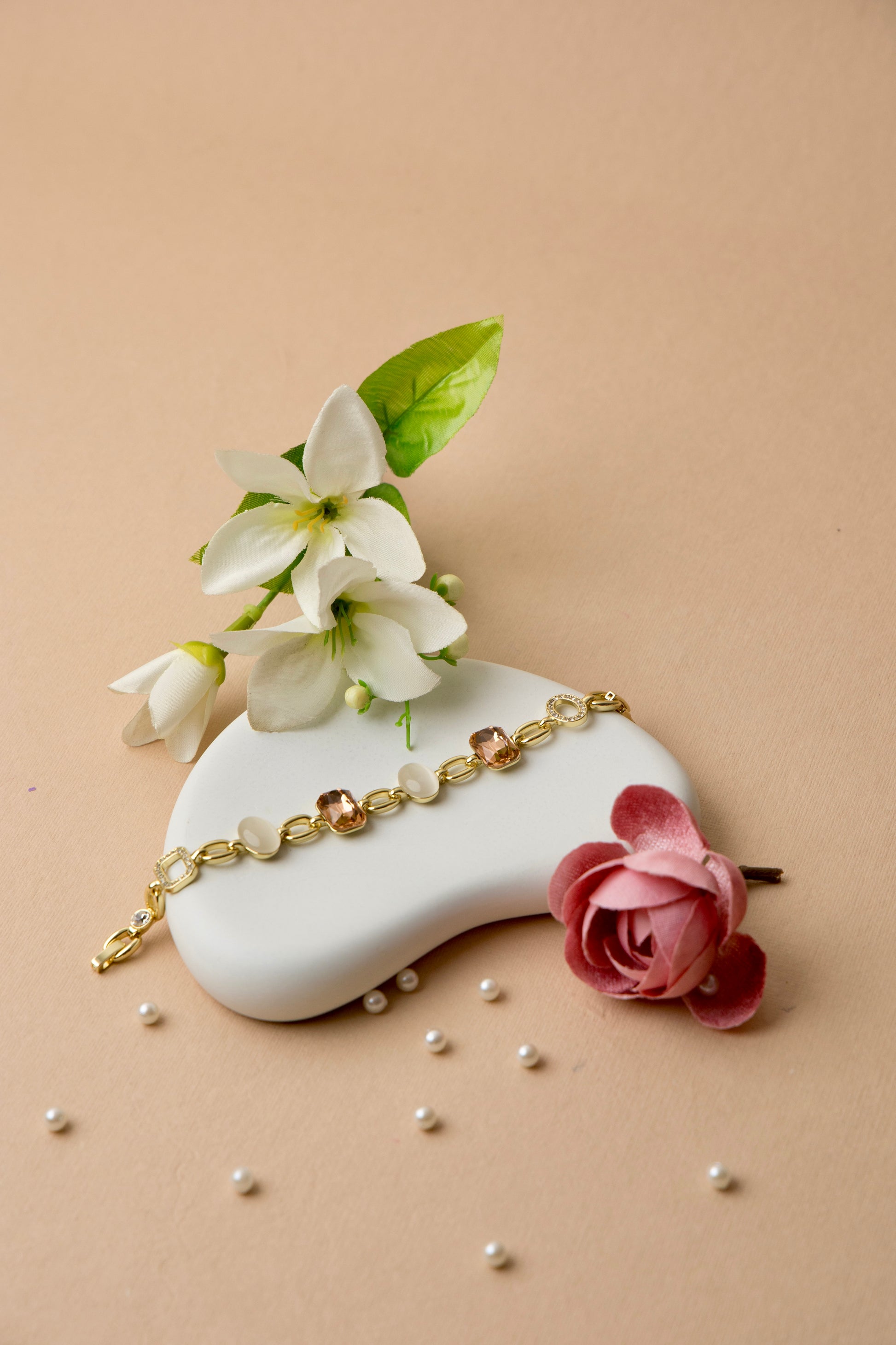 "Gold-plated bracelet featuring mocha crystals and ivory enamel, ideal for workwear or elegant neutral styling."