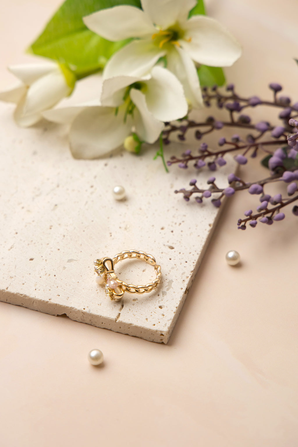 The Aurora Bow Ring is lavishly adorned with lustrous pearls and hand-set crystals in varying cuts and tones. 